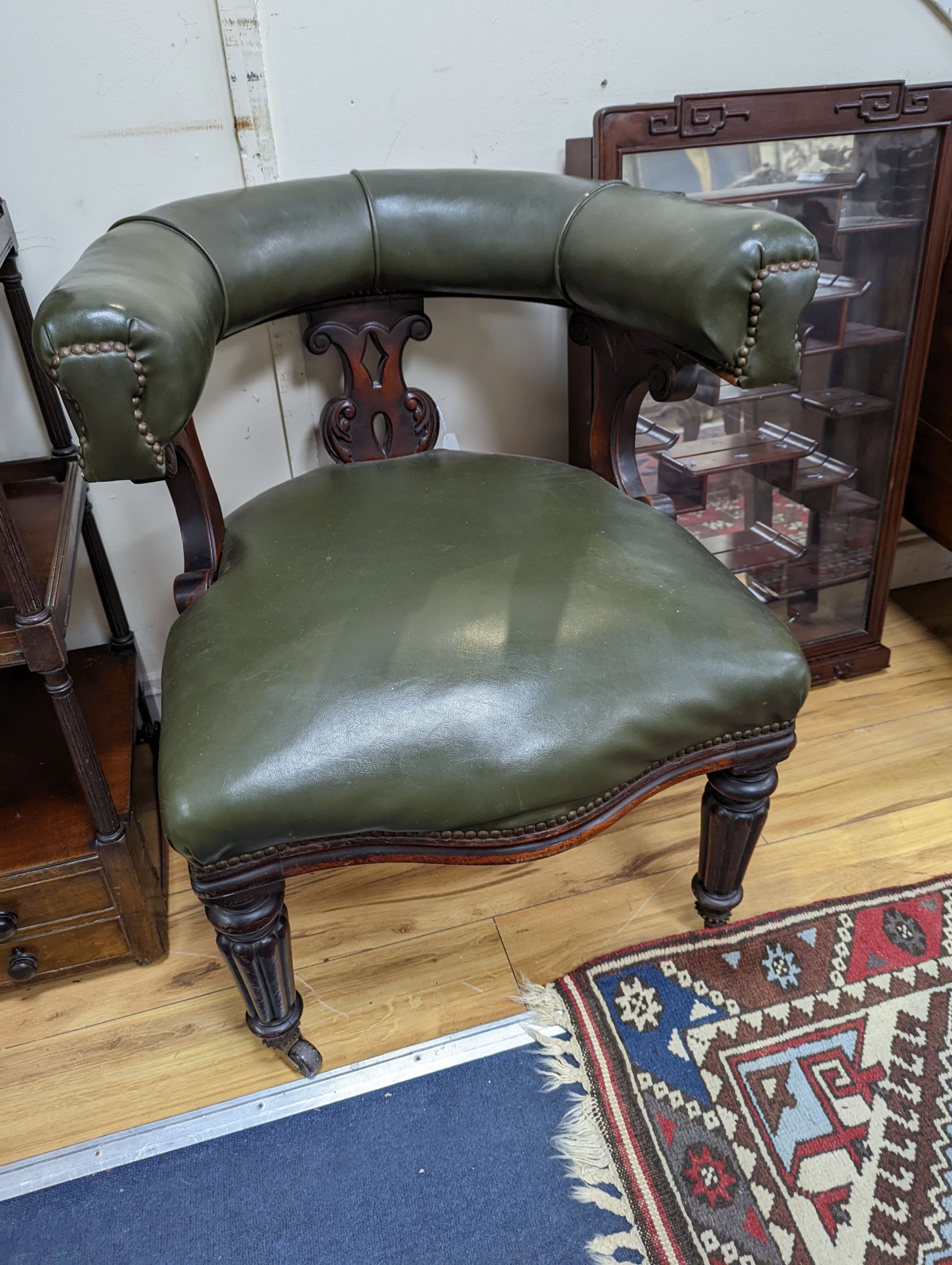 A Victorian mahogany tub framed chair upholstered in green leather, width 60cm, depth 58cm, height 66cm